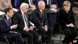 France's President Macron, German President Steinmeier, Wolfgang Schaeuble, President of the German Federal Parliament, and German Chancellor Merkel attend a meeting of the Bundestag in Berlin, Nov. 18, 2018, Germany's national day of mourning.