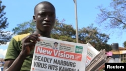 FILE - A news vendor displays newspapers in the Ugandan capital Kampala, Oct. 6, 2014. The World Health Organization is currently part of an effort working to rapidly contain an outbreak of the deadly Marburg virus disease in eastern Uganda on the border with Kenya, Oct. 20, 2017.