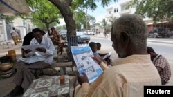FILE - People read newspapers in the streets of Somalia's capital Mogadishu May 3, 2011. Popular Somali newspaper Xog-Ogaal remains closed and its editor in detention for a second day.