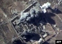 FILE - A video grab from Oct. 12, 2015, to show explosions after airstrikes carried out by Russian air force on what Russia says was an Islamic State ammunition depot in the Syrian province of Idlib.