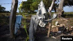 Clothing is pictured on a wire fence at site of unmarked graves where a forensic team and judicial authorities are working in after human skulls were found, in Alvarado, in Veracruz state, Mexico, March 19, 2017. 