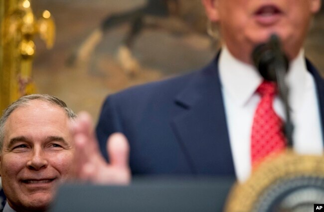 FILE - EPA administrator Scott Pruitt listens as President Donald Trump speaks before signing the Waters of the United States executive order, Feb. 28, 2017, in the Roosevelt Room of the White House.