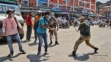 FILE - Policemen attack a photojournalist who was covering the Muharram procession in Srinagar on Aug. 17, 2021. (VOA/Faisal Bashir)