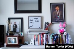 Inside his home, DACA recipient Juan Ulises Juarez showcases his achievements as a local TV reporter.
