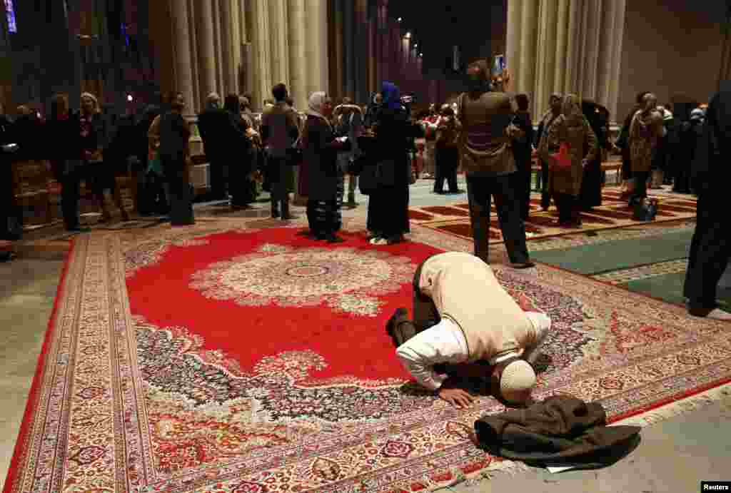 Omar Abdul-Malik prays alone as the Washington National Cathedral and five Muslim groups hold the first celebration of Muslim Friday Prayers, Jumaa, in the Cathedral&#39;s North Transept in Washington, D.C.