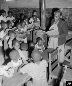 "Mama" Sarah L. Murphy teaches some of the 48 indigent and orphaned children in a two-room schoolhouse at Rockmart, Ga., June 23, 1950.