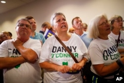 Supporters of Danny O'Connor, the Franklin County recorder, anxiously watch results during an election night watch party at the Ohio Civil Service Employees Association, Tuesday, Aug. 7, 2018, in Westerville, Ohio.