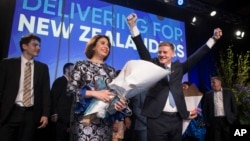 New Zealand Prime Minister Bill English, front right, celebrates with his wife Mary English at a party function in Auckland, New Zealand, Sept. 23, 2017. Prime Minister Bill English's National Party won the most votes in New Zealand's general election but not enough to form a government without help from other political parties.