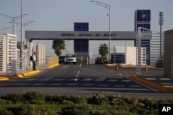 FILE - Cars exit the General Motors assembly plant in Villa de Reyes, outside San Luis Potosi, Mexico, Jan. 4, 2017.