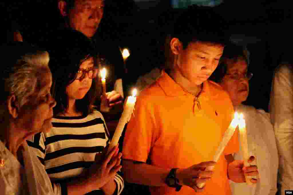 Young Cambodian-Americans take part in a candle vigil during a memorial service for Khmer Rouge victims at the Wat Buddhikaram Cambodian Buddhist temple in Silver Spring, Maryland, to mark the 40th anniversary of the takeover of the Khmer Rouge, on Friday, April 17, 2015. (Sophat Soeung/VOA Khmer)