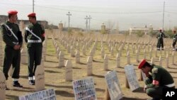 Kurdish soldiers stand in the graveyard for the victims of Halabja massacre. (File)