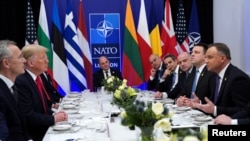 Sekretaris Jenderal NATO Jens Stoltenberg ketika Presiden AS Donald Trump dan Presiden Polandia Andrzej Duda berbicara ketika sedang makan siang yang berlangsung selama KTT NATO di Watford, Inggris, 4 Desember 2019. (Foto: Reuters / Kevin Lamarque)