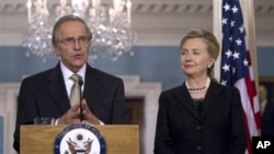 Secretary of State Hillary Rodham Clinton listens to Ambassador Princeton Lyman, during the announcement of his appointment as the new U.S. Special Envoy for Sudan, March 31, 2011, at the State Department in Washington.