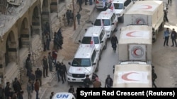 Trucks from Syrian Red Crescent and humanitarian partners are seen in Ghouta, Syria, March 5, 2018, in this picture obtained from social media. 