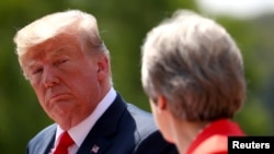Britain's Prime Minister Theresa May and U.S. President Donald Trump hold a joint news conference at Chequers, the official country residence of the Prime Minister, near Aylesbury, Britain, July 13, 2018. 