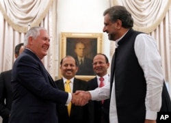 FILE - U.S. Secretary of State Rex Tillerson shakes hands with Pakistani Prime Minister Shahid Khan Abbasi before their meeting at the prime minister's residence, in Islamabad, Pakistan, Oct. 24, 2017.