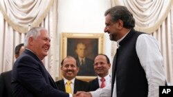FILE - U.S. Secretary of State Rex Tillerson shakes hands with Pakistani Prime Minister Shahid Khan Abbasi before their meeting at the prime minister's residence, in Islamabad, Pakistan, Oct. 24, 2017.
