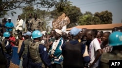 Residents of the PK5 district rally in front of the MINUSCA, the United Nations mission in Central African Republic's headquarters, calling for more security measures during a constitutional referendum, in the flashpoint enclave in Bangui, on Dec. 13, 2015.