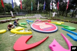 Workers add final touches to the ASEAN logo at the 27th Association of Southeast Asian Nations (ASEAN) summit in Kuala Lumpur, Malaysia, Nov. 19, 2015.