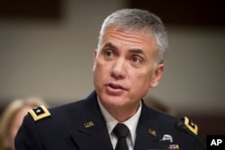 FILE - Army Lieutenant General Paul Nakasone appears before the Senate Armed Services Committee to discuss his qualifications as nominee to lead the National Security Agency and U.S. Cyber Command, during a hearing on Capitol Hill in Washington, March 1, 2018.