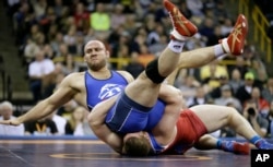 Tervel Dlagnev, top, is taken to the mat by Zach Rey during their 125-kilogram freestyle finals match at the U.S. Olympic Wrestling Team Trials, April 9, 2016, in Iowa City, Iowa.