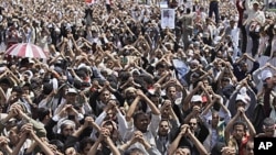Anti-government protesters gesture during a demonstration demanding the resignation of Yemeni President Ali Abdullah Saleh, in Sana'a, Friday, June 10, 2011