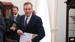 FILE - U.S. Trade Representative Robert Lighthizer arrives for a meeting with German Minister for Economic Affairs and Energy Brigitte Zypries in Washington, May 24, 2017. 