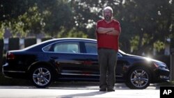 Bob Rand poses for a photo with his 2014 fully loaded Volkswagen diesel Passat, Sept. 23, 2015, in Pasadena, California.