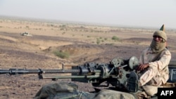 FILE: A Tuareg fighter of the Coordination of Movements of the Azawad (CMA) stand on a pick up truck with a machine gun near Kidal, northern Mali. Taken 9.28.2016