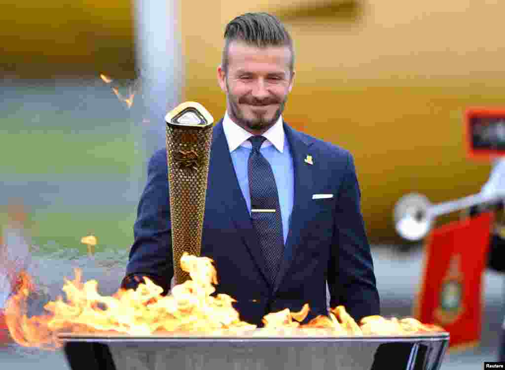 Beckham, a London 2012 Olympic Games ambassador, after lighting the Olympic torch in Cornwall, England, May 18, 2012.