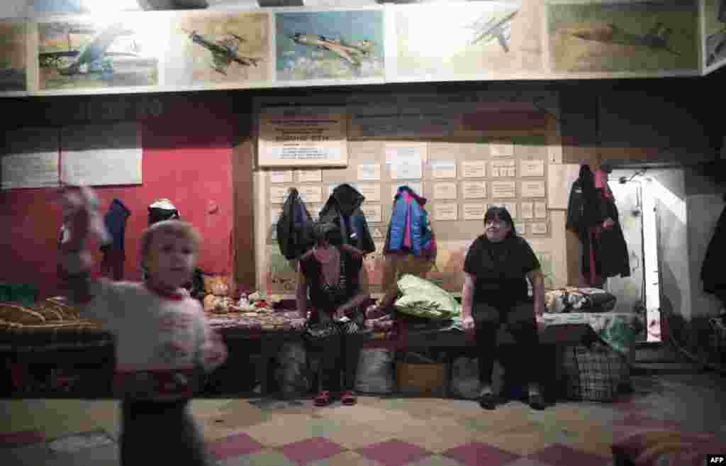 Residents of the Prtrovskiy neighborhood of Donetsk sit in a shelter. Most of the people in the shelter have been taking refuge for over four months, throughout constant fighting between the Kremlin-backed rebels and Ukrainian government troops.