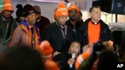 Cleo Pendleton, below, whose daughter was fatally shot by Chicago police in January, is comforted by the Rev. Al Sharpton as Spike Lee, second from left, listen to her speak during a rally for the prevention of gun violence, in New York, Dec. 1, 2015.