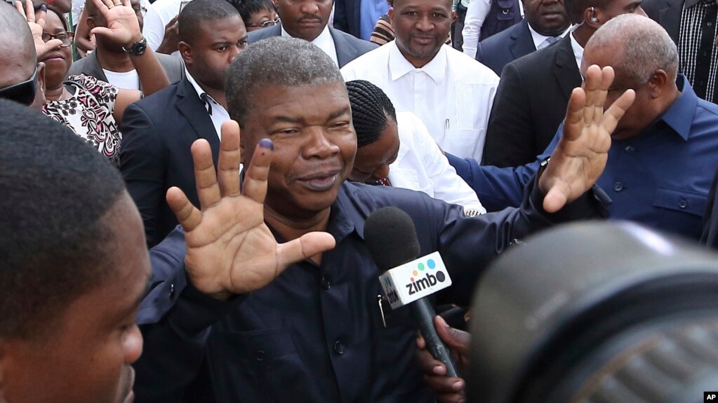 FILE - Joao Lourenco, shows his ink-stained finger as he faces the media after casting his vote in elections in Luanda, Angola.