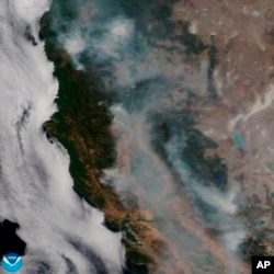 This satellite image released on Aug. 7, 2018 provided by NOAA shows the wildfires known as the Mendocino Complex, Calif. Northern California is grappling with the largest wildfire in California history, breaking a record set only months earlier.