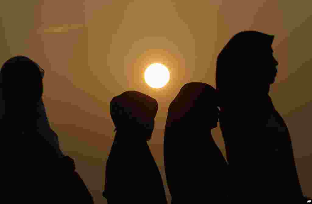 Indonesian Muslim women walk before the Eid al-Fitr prayer that marks the end of Ramadan Jakarta, August 8, 2013. 