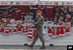 A soldiers patrols at the Christmas market along the Champs Elysees avenue in Paris, Nov. 24, 2015.
