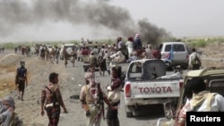 Fighters loyal to Yemen's President Abd-Rabbu Mansour Hadi gather on a road leading to the al-Anad military and air base in the country's southern province of Lahej Aug. 3, 2015. 