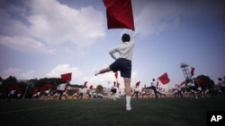 Students practice flag cheering routines at a Tokyo Korean junior and senior high school in Tokyo, Sept. 26, 2017. 
