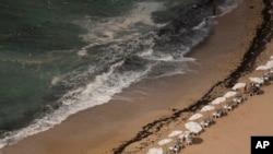 In this Aug. 8, 2019, photo, garbage creeps towards the shore at Stanley Beach in Alexandria, Egypt. (AP Photo/Maya Alleruzzo)