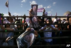 Supporters of Iranian President Hassan Rouhani in the May 19 presidential election attend his campaign rally, in Isfahan, Iran, Sunday, May 14, 2017.