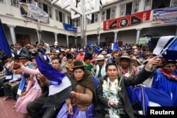 FILE - People attend a signing ceremony of an agreement between Bolivia and China to produce lithium at the salt flat of Coipasa and Pastos Grandes in Oruro, Bolivia, Feb. 6, 2019.