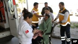 Medics take care of a rescued migrant at a local hospital in the Aegean resort of Didim, Turkey, March 6, 2016. Turkey's state-run news agency says 18 migrants have drowned off the Turkish coast while trying to reach Greece.