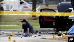 An FBI crime scene investigator documents the area of last week's attack in Garland, Texas, May 4, 2015.