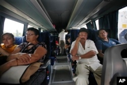 A migration official checks passengers on a bus, at a checkpoint on the highway in Tapachula, Chiapas state, Mexico, June 7, 2019.