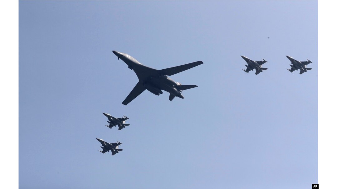 U.S. B-1 bomber, center, flies over Osan Air Base with U.S. jets in Pyeongtaek, South Korea, Tuesday, Sept. 13, 2016.
