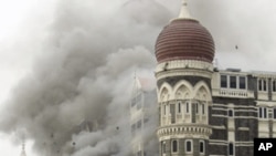 In this Saturday, Nov. 29, 2008 file picture, smoke billows from the landmark Taj Mahal hotel in Mumbai, India after an attack by gunmen