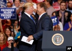 President Donald Trump, left, embraces Sen. Dean Heller, R-Nev., during a campaign rally, Sept. 20, 2018, in Las Vegas.