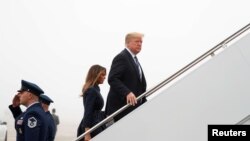 FILE - U.S. President Donald Trump and first lady Melania Trump board Air Force One as they depart Washington en route to Pennsylvania from Joint Base Andrews in Maryland, Sept. 11, 2018.