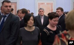 Members of Jehovah's Witnesses react in a court room after a judge's decision in Moscow, April 20, 2017. Russia's Supreme Court has banned the Jehovah's Witnesses from operating in the country.