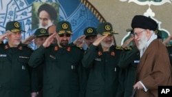 FILE - Ayatollah Ali Khamenei arriving at a graduation ceremony of the Revolutionary Guard's officers, as the deputy commander of the Guard, Hossein Salami (2nd R) and other salute him in Tehran. (Office of Iranian Supreme Leader via AP)